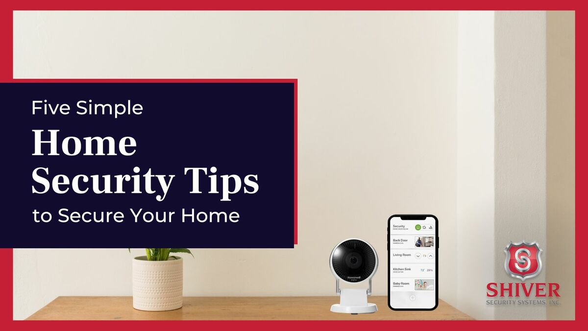 Security camera next to a smartphone on a desk